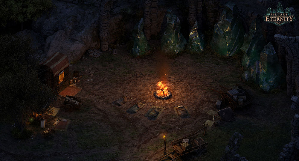 A campfire burns, lined with empty sleeping bags. Giant green crystal structures surround the area and there's a few wagons with goods unpacked for selling.