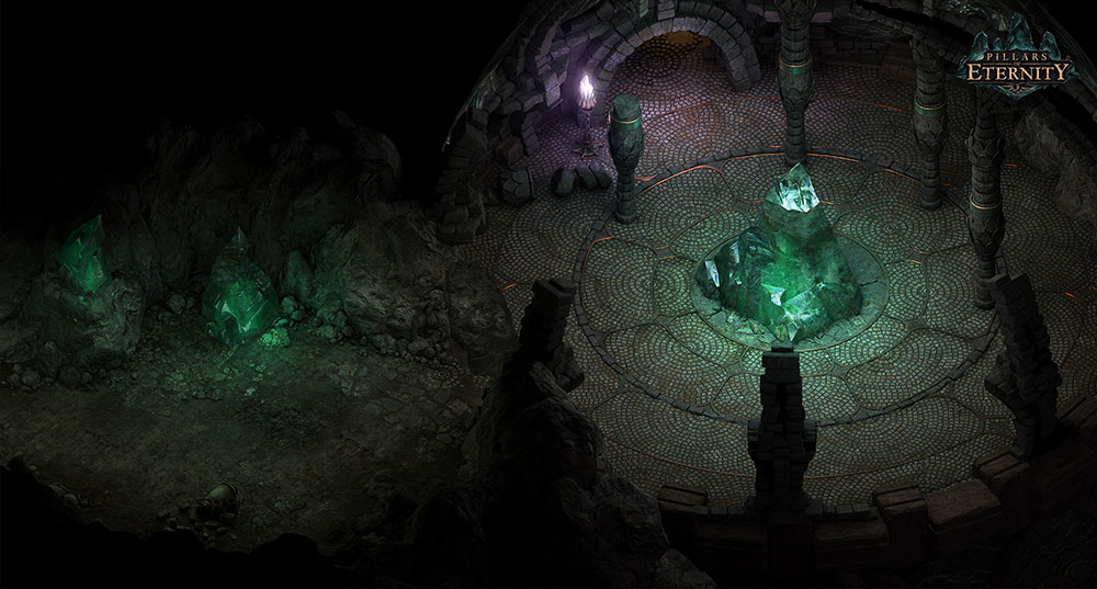 A large green crystal glows in the middle of some circular ruins. To the left is a cave passageway that also glows green.